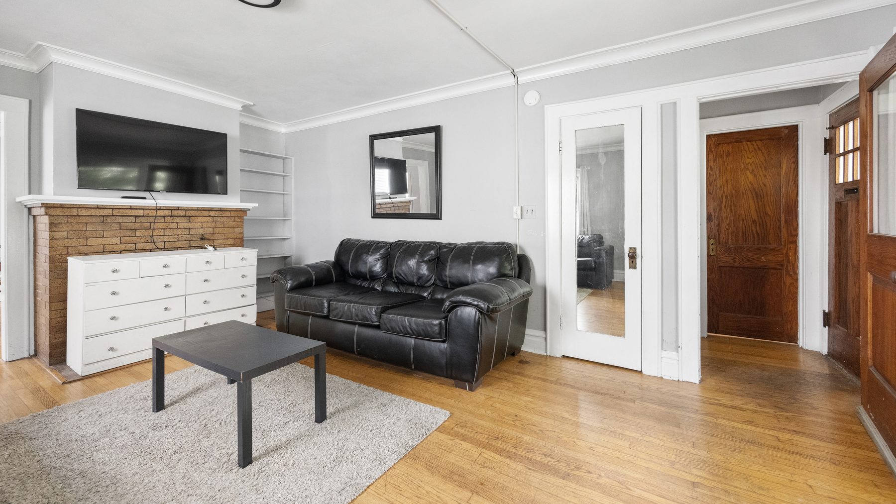823 Ackerman Avenue - living room with mounted TV and built-in shelving